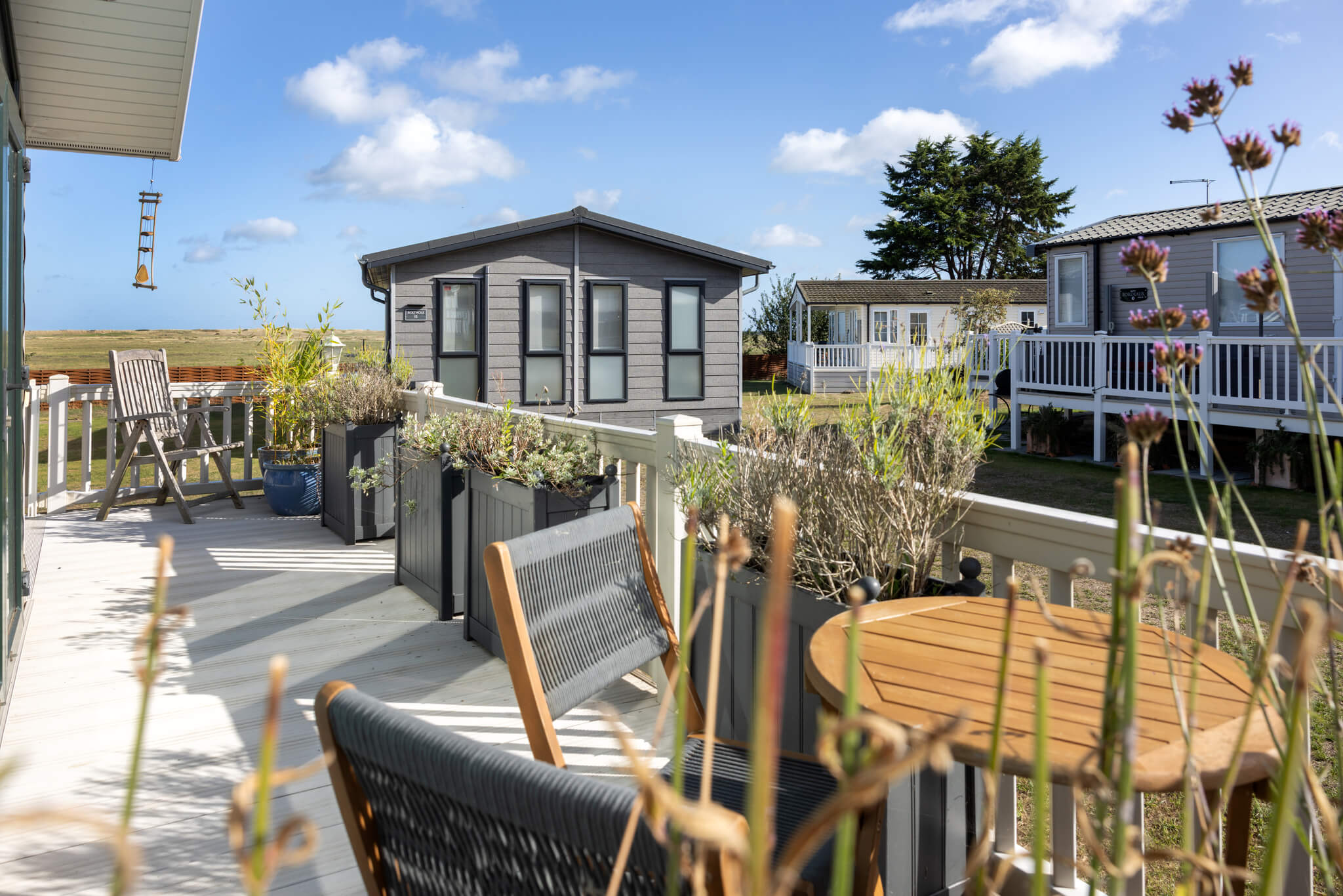 Caravan decking with outdoor furniture and planters