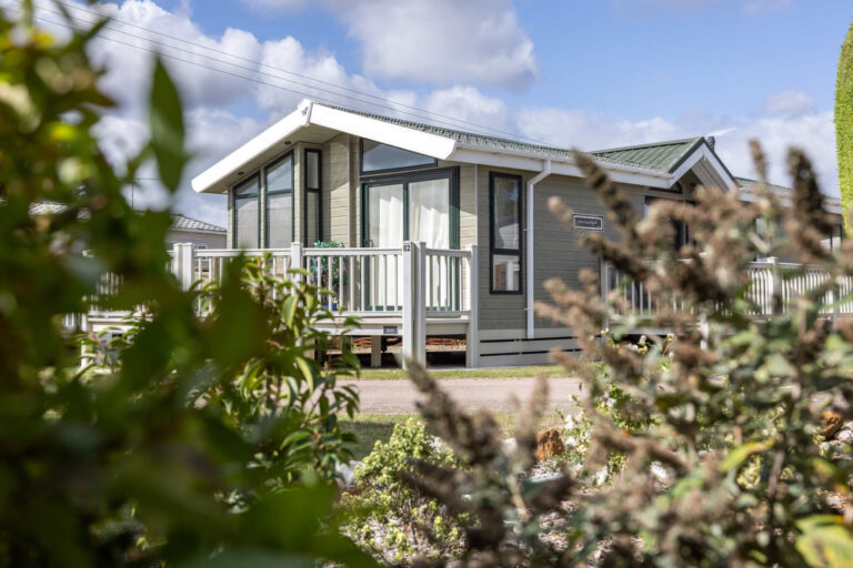 A caravan holiday home taken through some bushes
